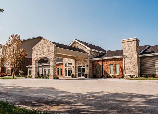 Walnut Senior Living building entrance with parking lot visible